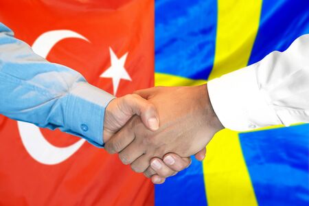 Business handshake on the background of two flags. Men handshake on the background of the Turkey and Sweden flag. Support conceptの写真素材