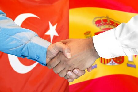 Business handshake on the background of two flags. Men handshake on the background of the Turkey and Spain flag. Support conceptの写真素材