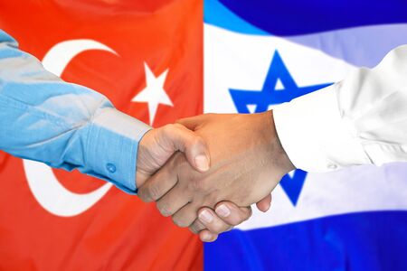 Business handshake on the background of two flags. Men handshake on the background of the Turkey and Israel flag. Support conceptの写真素材