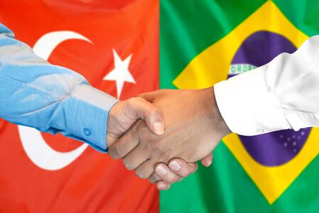 Business handshake on the background of two flags. Men handshake on the background of the Turkey and Brazil flag. Support conceptの写真素材