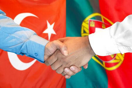 Business handshake on the background of two flags. Men handshake on the background of the Turkey and Portugal flag. Support conceptの写真素材