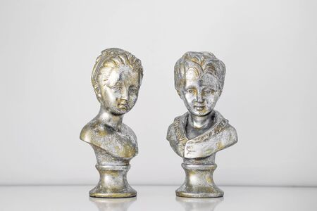 Plaster figure busts of girl and a boy isolated on white background. Card for valentines day.の写真素材