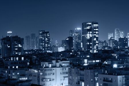 Night view of the city life. Light of the buildings shining with cool blue tones. View of night scene of Tel Aviv, Israel. Blue tone city scape.の写真素材