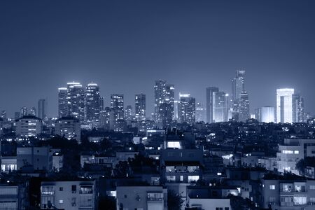 Night view of the city life. Light of the buildings shining with cool blue tones. View of night scene of Tel Aviv, Israel. Blue tone city scape.の写真素材