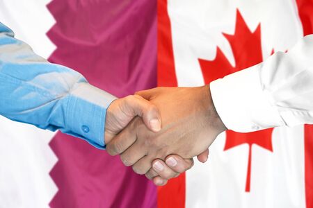 Business handshake on the background of two flags. Men handshake on the background of the Qatar and Canada flag. Support conceptの写真素材
