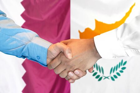 Business handshake on the background of two flags. Men handshake on the background of the Qatar and Cyprus flag. Support conceptの写真素材