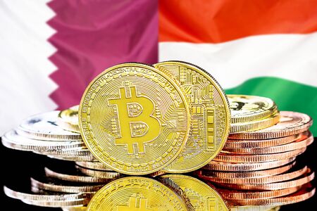 Concept for investors in cryptocurrency and Blockchain technology in the Qatar and Hungary. Bitcoins on the background of the flag Qatar and Hungary.の写真素材