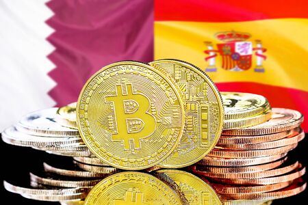 Concept for investors in cryptocurrency and Blockchain technology in the Qatar and Spain. Bitcoins on the background of the flag Qatar and Spain.の写真素材