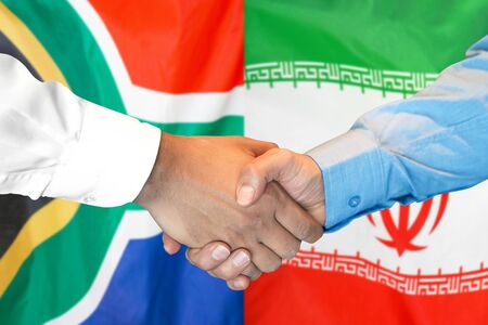 Business handshake on the background of two flags. Men handshake on the background of the South Africa and Iran flag. Support conceptの写真素材
