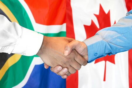 Business handshake on the background of two flags. Men handshake on the background of the South Africa and Canada flag. Support concept