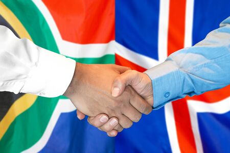 Business handshake on the background of two flags. Men handshake on the background of the South Africa and Iceland flag. Support conceptの写真素材