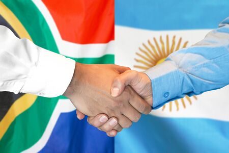 Business handshake on the background of two flags. Men handshake on the background of the South Africa and Argentina flag. Support conceptの写真素材