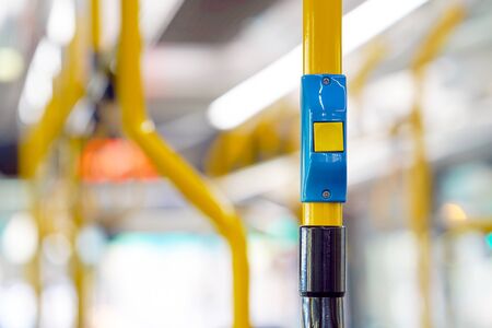 Yellow stop button for bus or tram. Press the button to request the bus driver for get off at the...