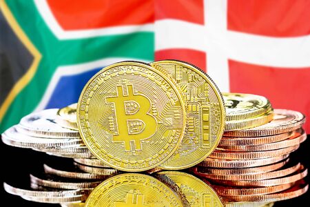 Concept for investors in cryptocurrency and Blockchain technology in the South Africa and Denmark. Bitcoins on the background of the flag South Africa and Denmark.の写真素材