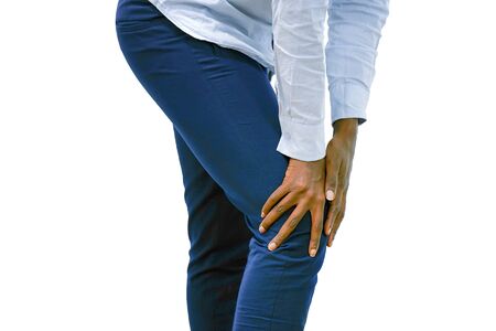 Closeup african female hand on leg with painful knees isolated on a white background. Young african...