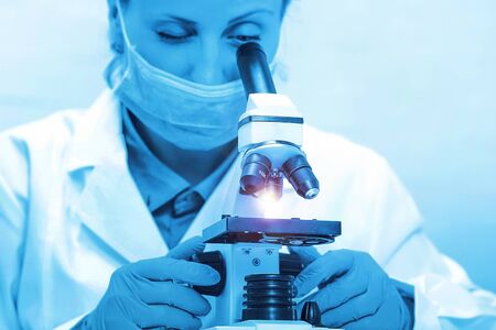 Laboratory microscope. Scientist with a microscope studying samples and liquid. Medical research...