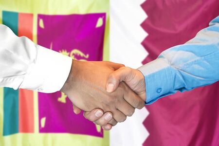 Business handshake on the background of two flags. Men handshake on the background of the Sri Lanka and Qatar flag. Support conceptの写真素材