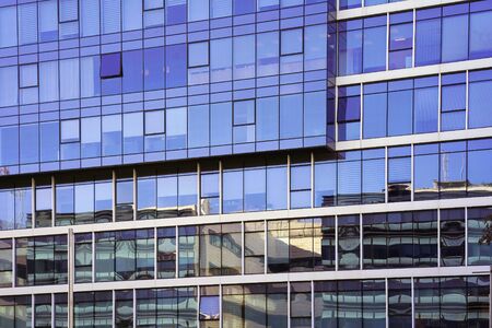 Abstract architecture. Glass blue square Windows of facade modern city business building skyscraper....