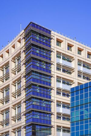 Facade modern city business building skyscraper. Modern apartment buildings in new neighborhood. Abstract architecture. Windows of a building, texture.の写真素材