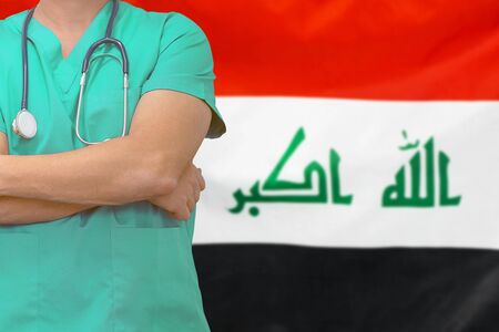 Male surgeon or doctor with stethoscope on the background of the Iraq flag. Health care and medical concept. Surgery concept in Iraq.の写真素材