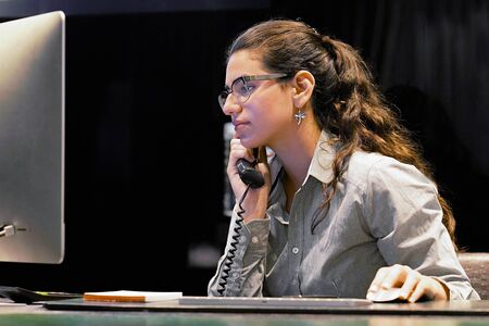Portrait of office worker, manager woman secretary answering phone calls and talking with customers....