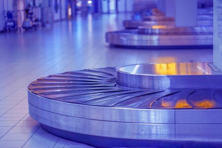 Baggage claim area in the airport, abstract luggage line. Empty airport baggage belt. Selective focus.の写真素材