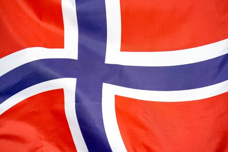 Fabric texture flag of Norway. Flag of Norway waving in the wind. Norway flag is depicted on a sports cloth fabric with many folds. Sport team banner.の写真素材