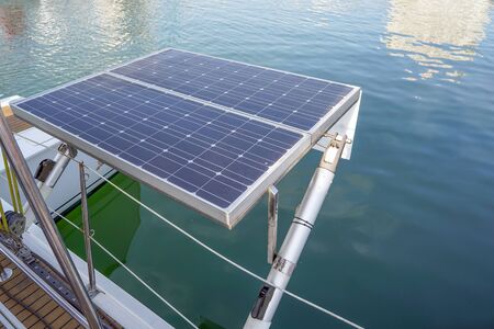 Solar panel on sailing yacht in the sea. Monocrystalline and Polycrystalline Solar Panels in yachting. Solar panel, photovoltaic, alternative electricity source on boat.の写真素材
