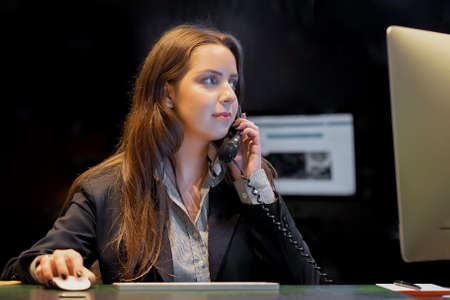 Woman answers customer calls in a call center. The secretary answers the phone and talks with...