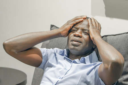 Loss of a loved one. Grief in the family. Sad face depressed elderly african man. Very sad elderly man. Concept of loneliness and pain.の写真素材