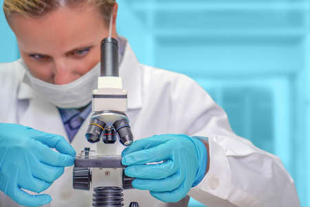 Scientist woman looks at test sample for microscope. Medic researcher using microscope. Medical...