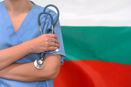 Female surgeon or doctor with stethoscope in hand on the background of the Bulgaria flag. Surgery concept in Bulgariaの写真素材