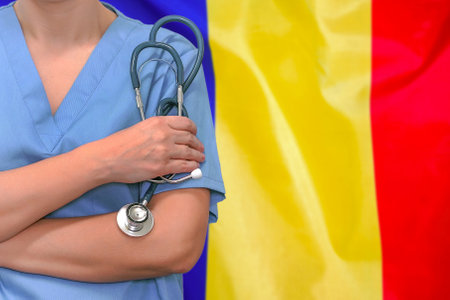 Female surgeon or doctor with stethoscope in hand on the background of the Moldova flag. Surgery concept in Moldovaの写真素材