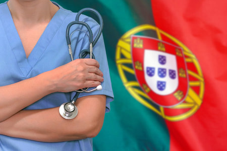 Female surgeon or doctor with stethoscope in hand on the background of the Portugal flag. Surgery concept in Portugalの写真素材