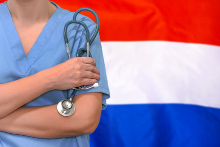 Female surgeon or doctor with stethoscope in hand on the background of the Netherlands flag. Surgery concept in Netherlandsの写真素材