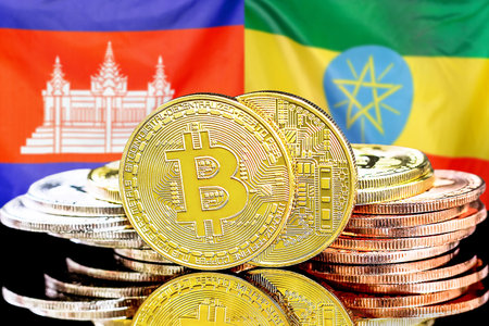 Concept for investors in cryptocurrency and Blockchain technology in the Cambodia and Ethiopia. Bitcoins on the background of the flag Cambodia and Ethiopia.の写真素材
