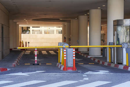 Barrier at Entrance and exit of a car Parking garage. barrier in a car park. Exit from underground parking. Underground parking / garage. Interior of parkingの写真素材