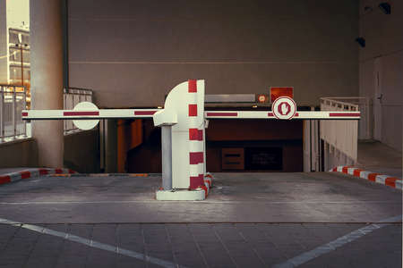 Barrier at Entrance and exit of a car Parking garage. barrier in a car park. Exit from underground parking. Underground parking, garage. Interior of parkingの写真素材