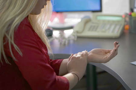Closeup hand of office manager woman pain. Hands hurt.の写真素材