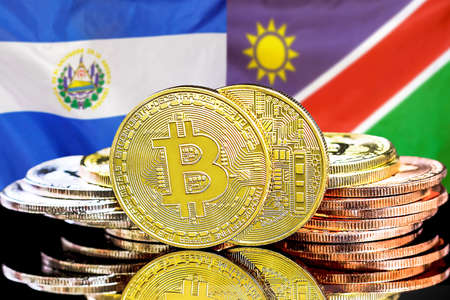 Concept for investors in cryptocurrency and Blockchain technology in El Salvador and Namibia. Bitcoins on the background of the flag El Salvador and Namibiaの写真素材