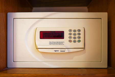 White small home or hotel safe with keypad. Safe box in hotel room wardrobeの写真素材