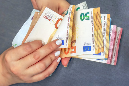 Woman hand with euro. Businesswoman hands hold and counting euro banknotes. Concept of corruption and bribery in Europeの写真素材