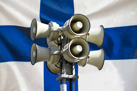 Street alarm loudspeaker on Finland flag background. Loudspeaker on the street. The siren of air alarmの写真素材