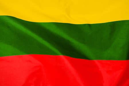 Fabric texture flag of Lithuania. Flag of Lithuania waving in the wind. Lithuania flag is depicted on a sports cloth fabric with many folds. sport team bannerの写真素材