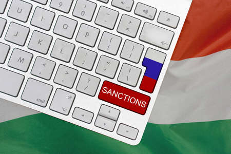 White computer keyboard with button of flag Russia and red button with word of sanctions on Hungary flag background. Financial and economic regulation sanctions Hungary against Russiaの写真素材
