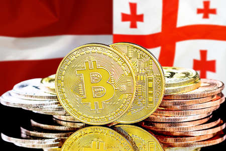 Bitcoins on the background of flag Latvia and Georgia. Concept for investors in cryptocurrency and Blockchain technology in Latvia and Georgiaの写真素材