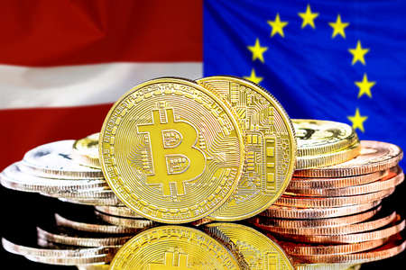 Bitcoins on the background of flag Latvia and European Union. Concept for investors in cryptocurrency and Blockchain technology in Latvia and EUの写真素材