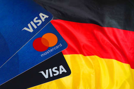 Visa Card, Mastercard, debit cards on German flag background. March 10, 2022. Tel Aviv. Israelのeditorial素材