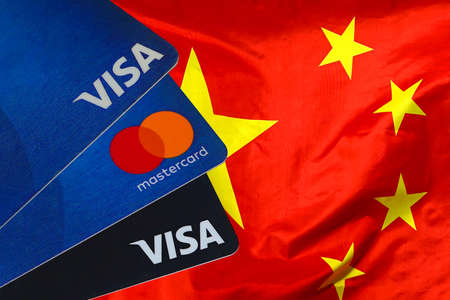 Visa Card, Mastercard, debit cards on China flag background. March 10, 2022. Tel Aviv. Israelのeditorial素材