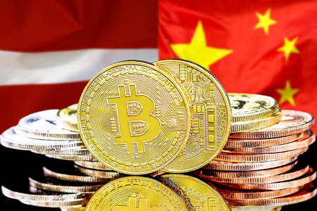 Bitcoins on the background of flag Latvia and China. Concept for investors in cryptocurrency and Blockchain technology in Latvia and Chinaの写真素材